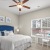 a bedroom with a bed and a fan