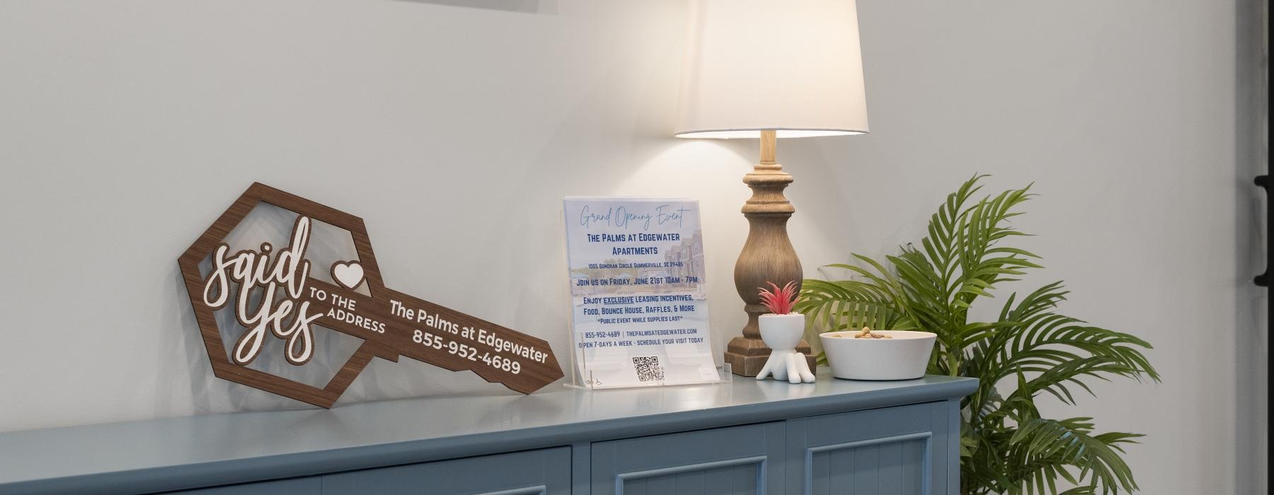 a blue cabinet with a lamp and a plant next to it