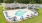 a swimming pool with a building in the background
