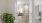 a room with white doors and a plant in it