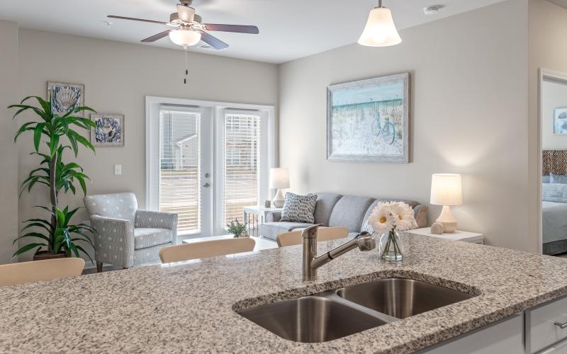 a living room with a marble countertop and a large chandelier