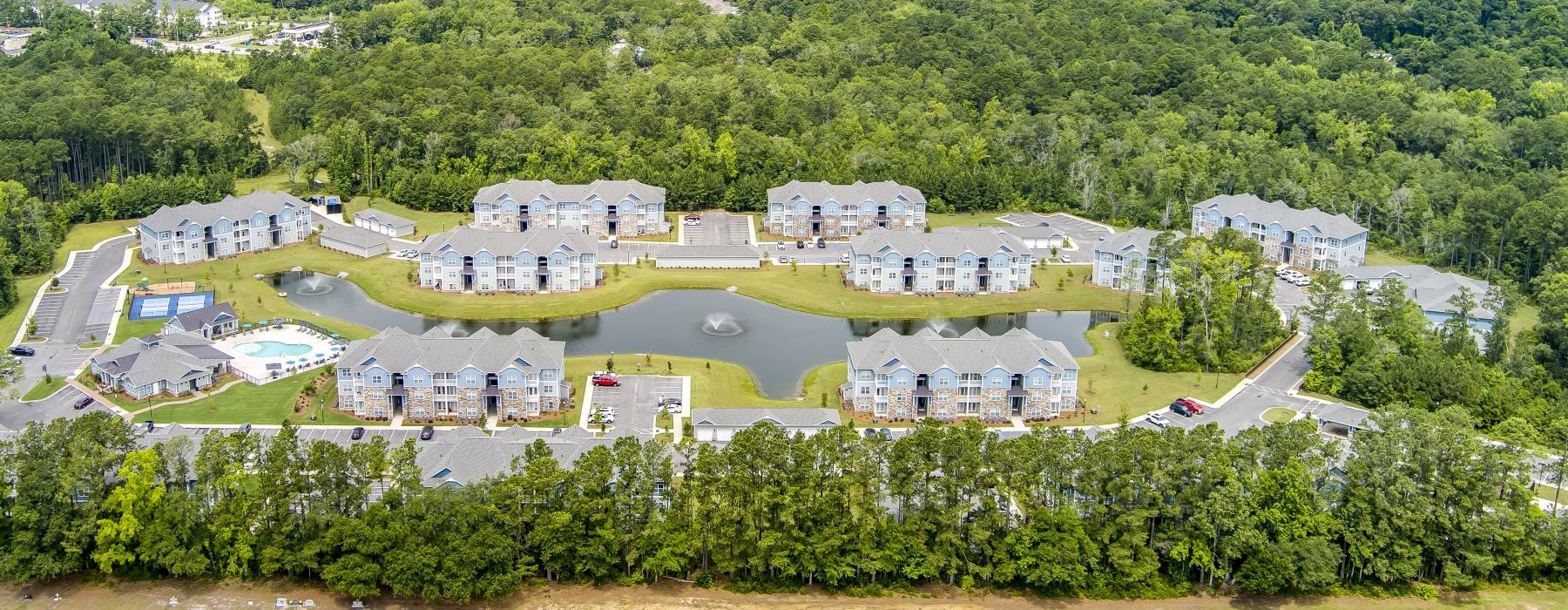 a group of buildings in a wooded area