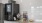 a kitchen counter with a tv and bottles of alcohol on it